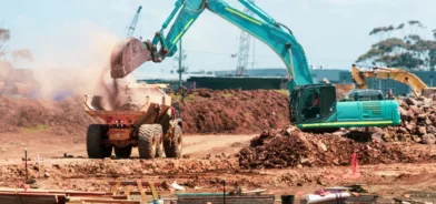 Caminhão e trator em obra, em foto que ilustra post sobre Estudo de Viabilidade Ambiental para obras públicas. Foto: Troy Mortier/Unsplash.