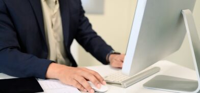 Homem usando computador, em foto que ilustra post sobre Domicílio Tributário Eletrônico (DTE). Reprodução: prathanchorruangsak/Envato.